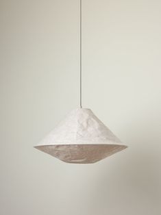 a white light hanging from a ceiling in a room