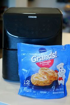 a bag of food sitting on top of a counter next to a black microwave oven