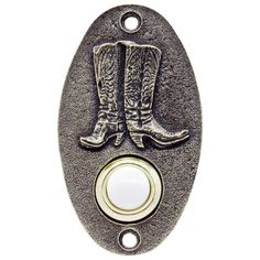 a metal button with cowboy boots on the front and white buttons in the back for an appliance