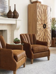 a living room with two chairs and a fireplace