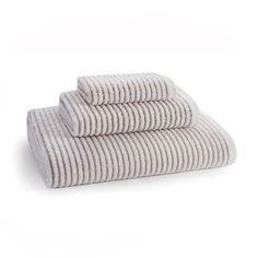 three towels stacked on top of each other in front of a white background with stripes