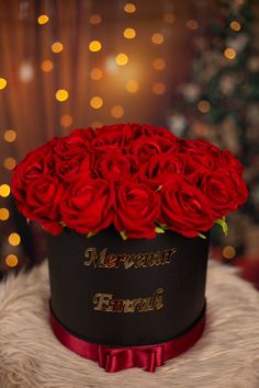 a black hat with red roses in it on top of a furnishing area