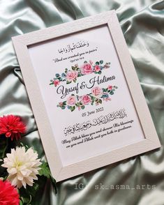 an arabic wedding card with flowers on the bed