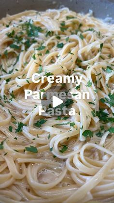 a bowl filled with pasta and parsley on top of it