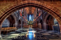 the inside of a church with pews and stained glass windows