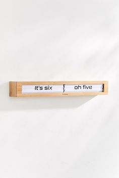 a wooden ruler with words on it that say it's six o'clock