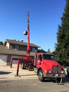 a red truck parked in front of a house next to a tall pole with an antenna on it