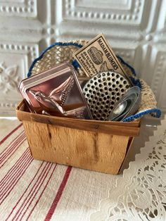 a wooden box filled with lots of different types of items on top of a table