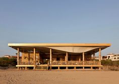 a wooden structure sitting on top of a sandy beach