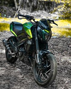 a green and black motorcycle parked in the woods