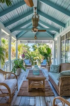 a covered porch with wicker furniture and plants