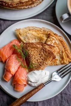 two white plates topped with different types of food