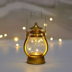 an old fashioned lantern is lit up with fairy lights