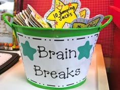 a bucket filled with lots of books on top of a table