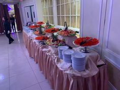 a buffet table with plates and cups on it