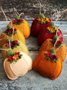 four felt pumpkins with flowers on them