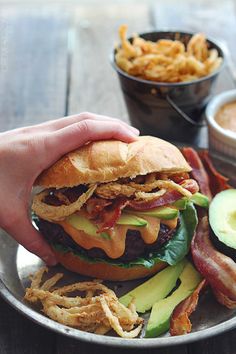 a plate with a bacon, lettuce and cheese burger