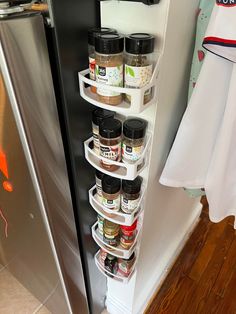 a refrigerator door is open with spices in it