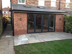 a brick building with sliding glass doors on the outside