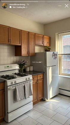 a white refrigerator freezer sitting inside of a kitchen next to a stove top oven