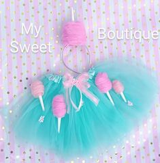 a blue tutu skirt with pink lollipops on it and the words, my sweet boutique