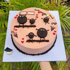 a birthday cake decorated with black and red decorations