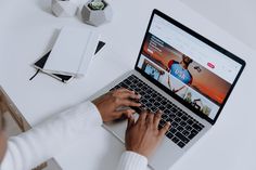 a person using a laptop computer on a desk