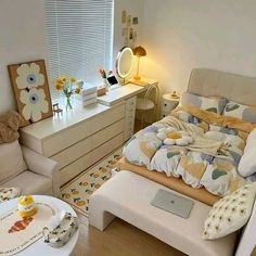 a bed room with a neatly made bed next to a desk and chair in front of a window