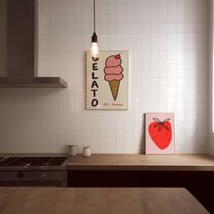 an ice cream cone is hanging on the wall next to a kitchen counter with a light above it