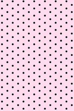 a pink background with black polka dots