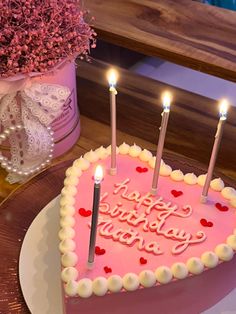 a heart shaped cake with candles on it