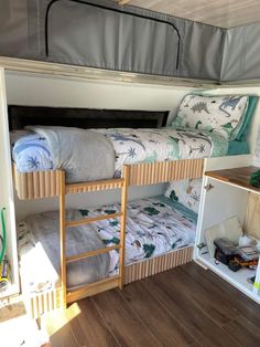 bunk beds in the back of a camper with storage space for toys and other items