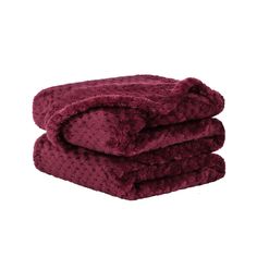 two towels stacked on top of each other in maroon color, one folded and the other rolled up