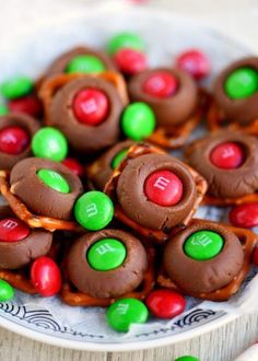 a white plate topped with chocolate covered pretzels and m & m candies