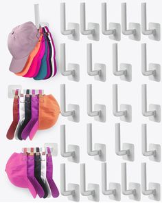 several pairs of socks hanging from hooks on a wall with hats and gloves in them