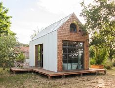 the tiny house is built on a wooden platform