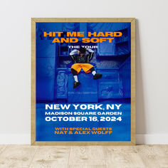 the poster for hit me hard and soft's new york tour is displayed in front of a white wall