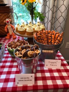 a table topped with lots of cupcakes and treats