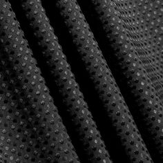 black and white photo of fabric with small polka dots on the side, close up