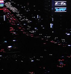 a city street filled with lots of traffic at night