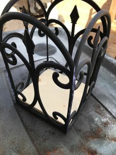 a metal object sitting on top of a cement floor next to a window sill