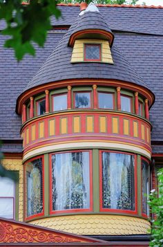 an ornate house with red and yellow trim