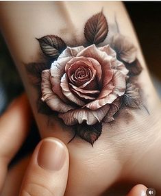 a woman's hand with a rose tattoo on it