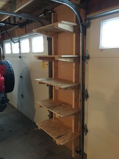 the inside of a garage with shelves and tools