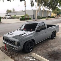 a silver truck parked on the side of a road