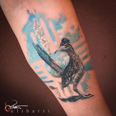 an arm with a bird and flowers on it