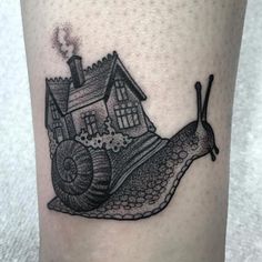 a snail with a house on it's back is depicted in this tattoo design