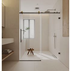 a bathroom with a walk in shower next to a sink and mirror on the wall