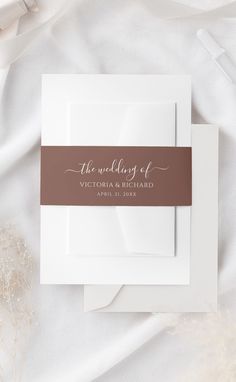 the wedding of victoria and richard is shown on top of a white envelope with a brown ribbon