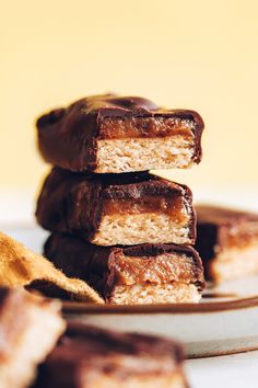 three pieces of chocolate peanut butter bars stacked on top of each other